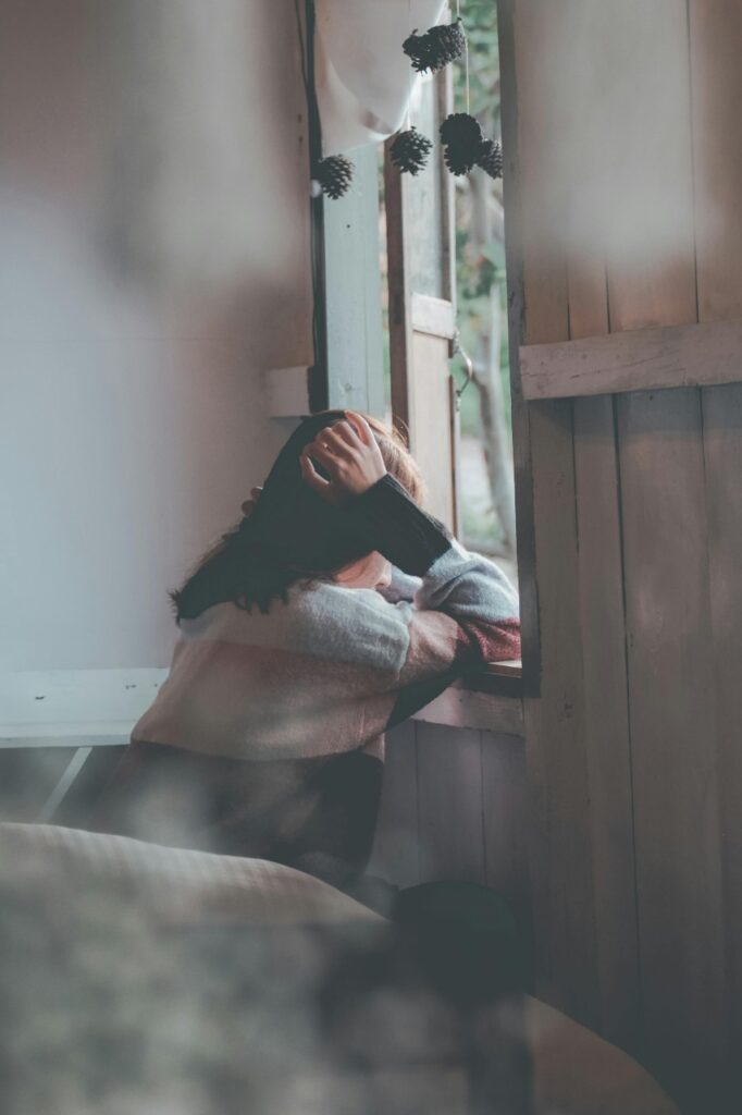 a Person Leaning on Wooden Window